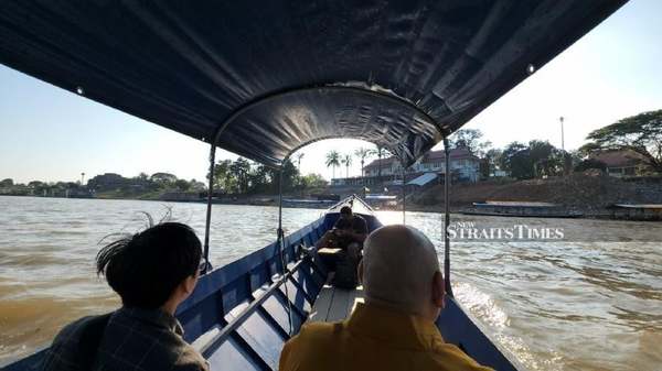 MHO taking a boat ride to the GTSEZ across the Mekong River during the recent rescue mission.