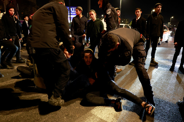 Israeli forces remove people blocking a road to protest a ceasefire deal, which they believe compromises Israel's security, near the Prime Minister's office in Jerusalem on 15 January.