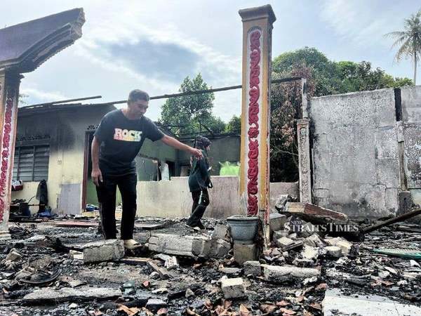 Ibrahim Ali, 59, and his wife, two of the victims of the fires, surveying their destroyed home.