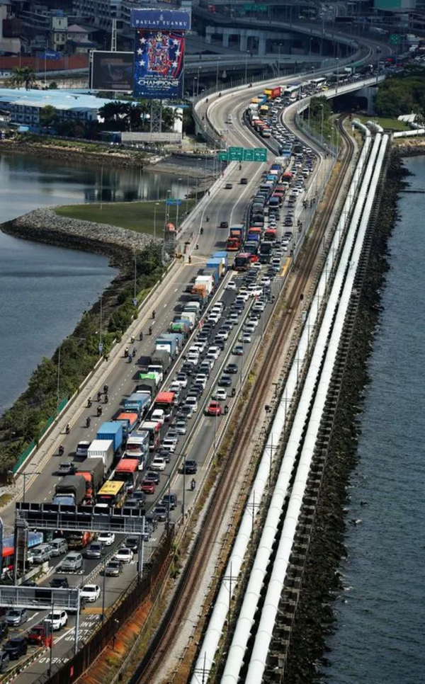 File photo of commuters crossing the Woodlands Causeway to Singapore from Johor.