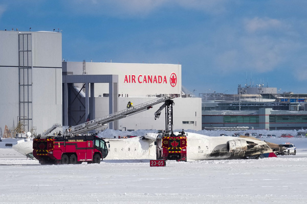 First responders work at the Delta Air Lines plane crash site at Toronto Pearson International Airport in Mississauga, Ontario, Canada on 17 February.