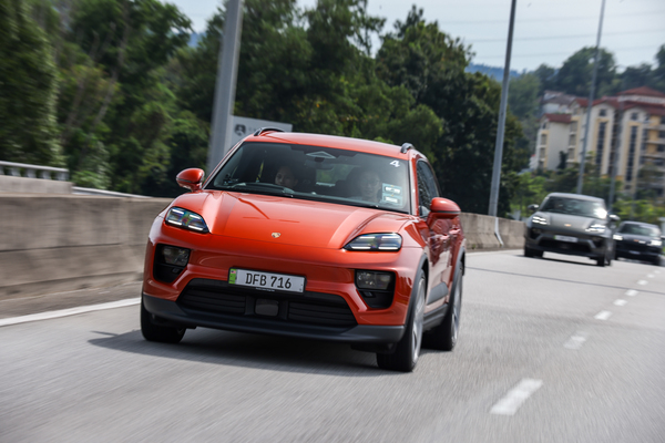 The Macan 4 in a striking orange tone.