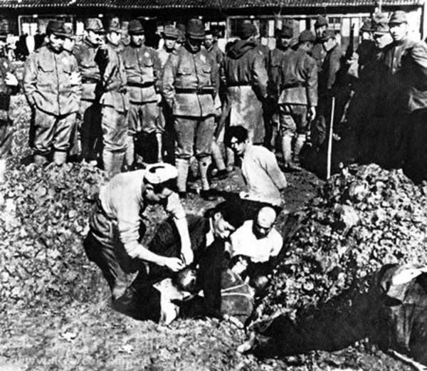 Japanese soldiers burying Chinese civilians alive during the Nanking Massacre.