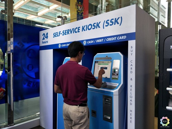 touch n go self service kiosk man in red shirt