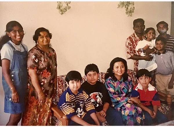 Johor Permaisuri Raja Zarith Sofiah (seated) and her children with Mohan and his family at their home on Deepavali day.