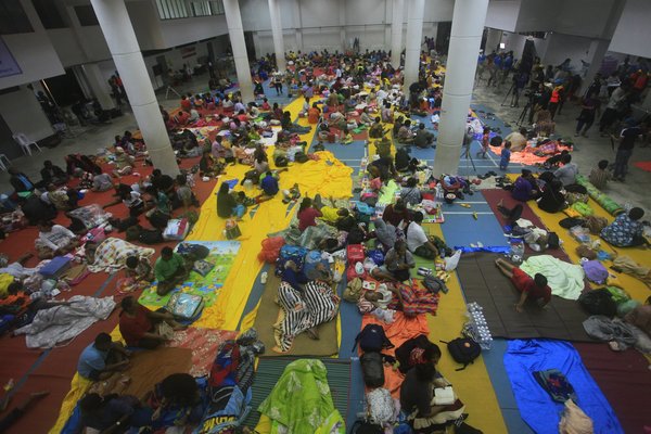 Thai people sleep at an evacuation centre in Nakhon Si Thammarat, Thailand.