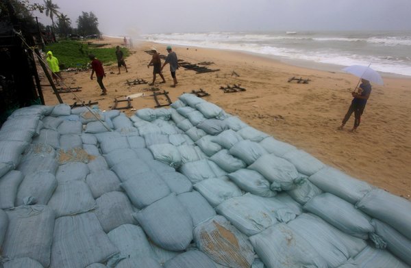 Thai people prepare for the tropical storm that is said to bring heavy rains and high waves.