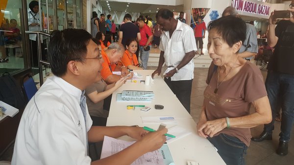 Senior citizens collecting their appreciation token in January 2018.