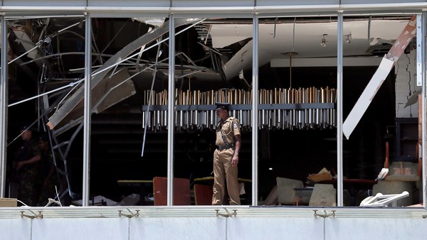 A police officer inspecting the scene of the explosion at Shangri-La hotel.