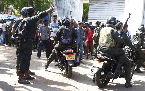 Police arriving at the scene of the eighth explosion.