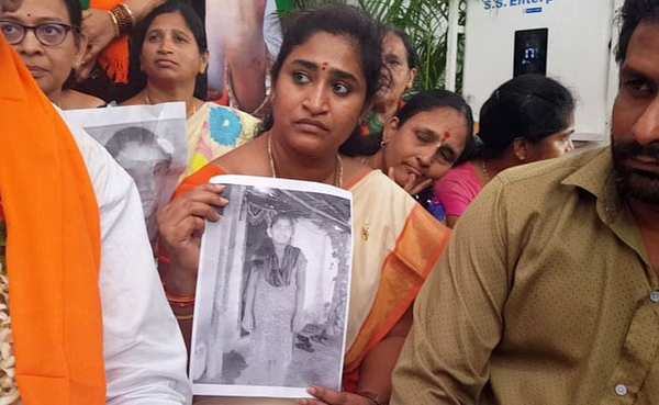 Activists holding photos of students who committed suicide over faulty exam results.