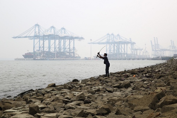 A man is seen fishing on a hazy day in Northport Klang on 9 September.