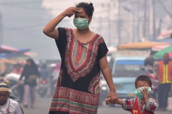 A mother and her child wearing masks in Pekanbaru, Riau on Tuesday, 10 September.