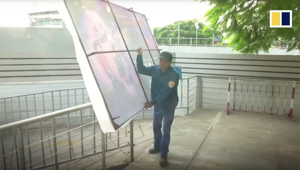 An ‘Abominable’ poster being removed by a worker in Vietnam.