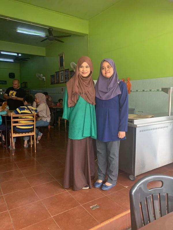 (Left to right) Nasi Beriani Haji Tamby Padang restaurant owner Amelia Tamby Hussin with one of her customers.