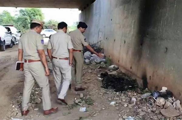 Police officers inspecting the site where they found the body the victim on the outskirts of Hyderabad.