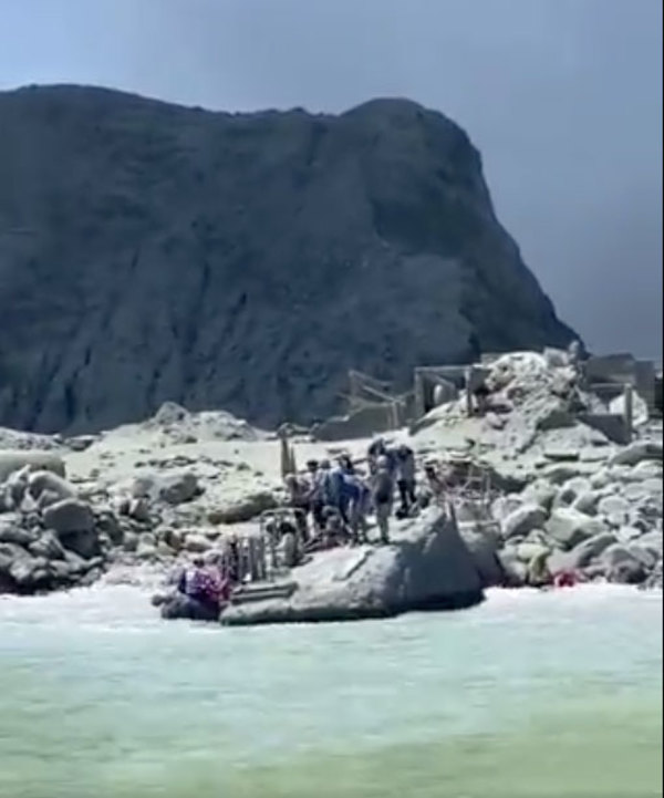 Tourists trying to escape White Island after the eruption yesterday.