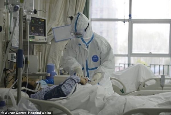 A doctor in Central Hospital of Wuhan donning full-body hazardous material suit while looking after patients.