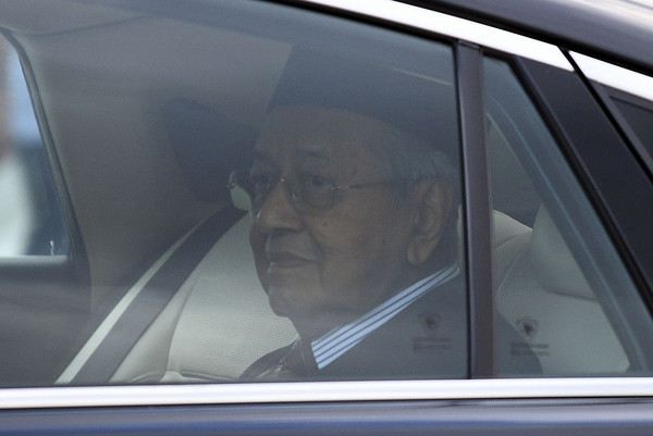 Dr Mahathir looks on as he leaves the Palace on 24 February.