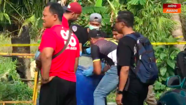 Police officers transferring the barrel filled with Mohd Hasnul's remains to Hospital Sultanah Bahiyah for a postmortem.