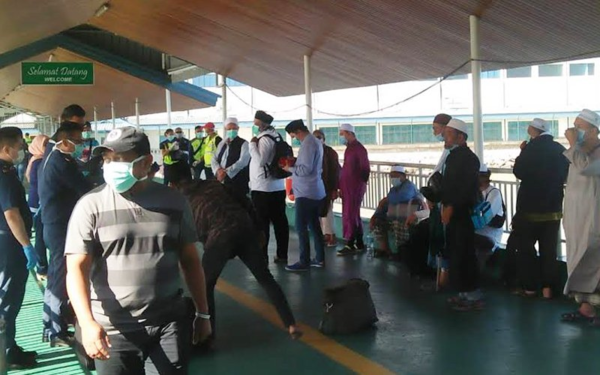 12 of the tabligh attendees arriving at the Tawau Customs, Immigration, and Quarantine Centre in Sabah after Indonesia cancelled the 'World Ijtima Asia Zone 2020' event in Sulawesi, Indonesia.