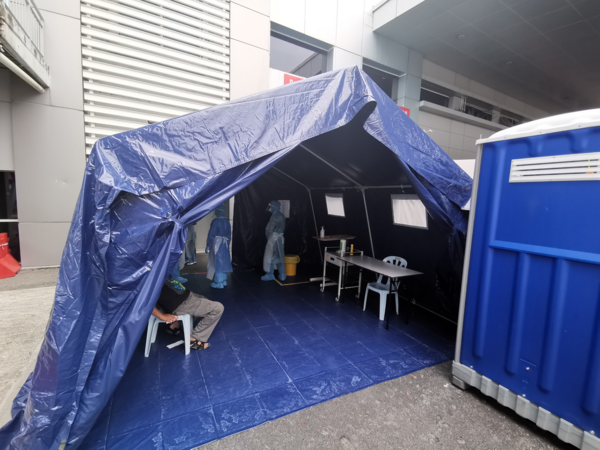 Malaysia setting up outdoor tents to run COVID-19 tests.