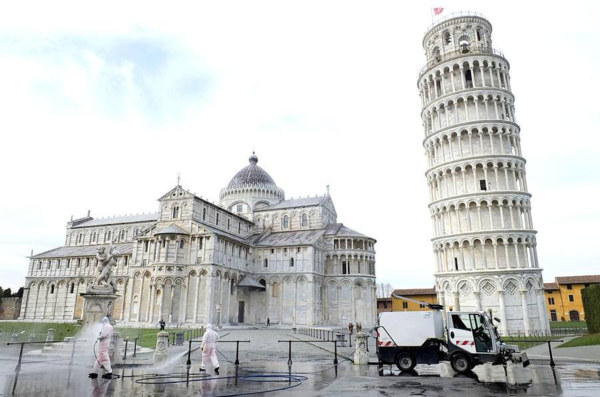 Local authorities disinfecting the area outside of the Leaning Tower of Pisa, Italy.