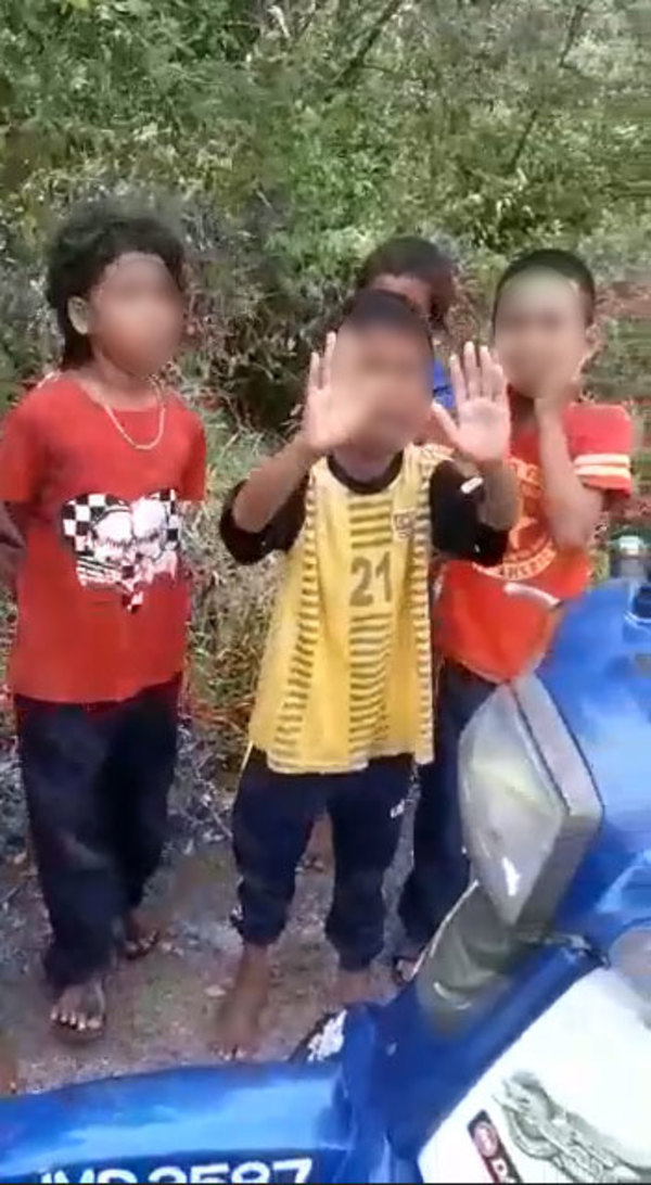 A child donned in a Team Malaysia jersey is seen putting up his hands in the air during the arrest scare.