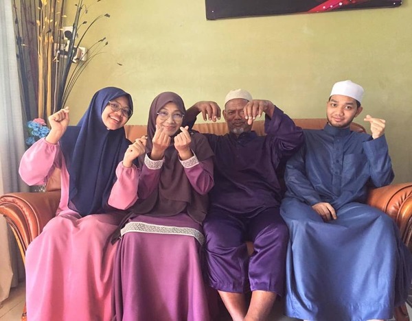 Haziq with his parents and older sister.