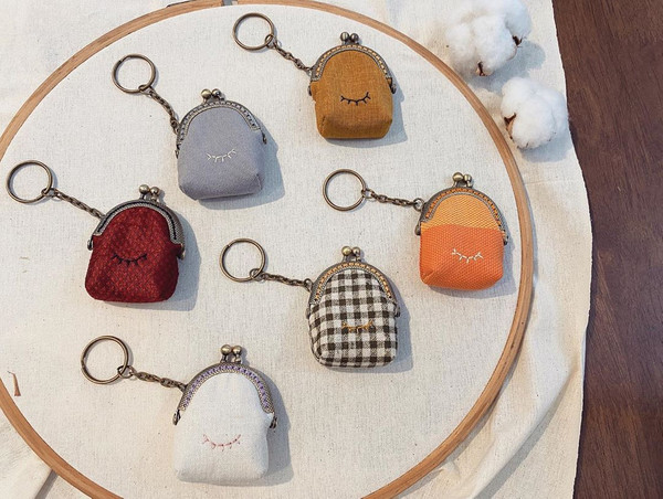 Mini clasp purse keychains with embroideries.