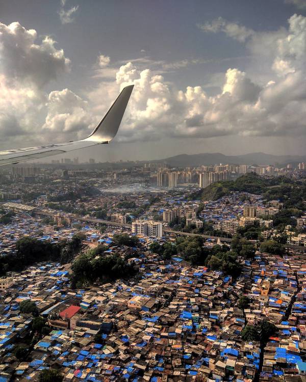 I took this shot back in 2017 during the monsoon season. My favourite thing about this photo is the surrealism embedded in the view overlooking the tarpaulin-covered houses in Bombay, where lies one of Asia's largest slums.