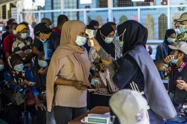 Voters queuing at a polling station in Sabah during the state election on 26 September.