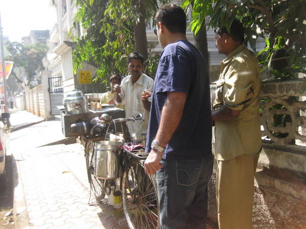 Seen here, a guy selling idly sambhar on his bicycle in the streets of Mumbai.