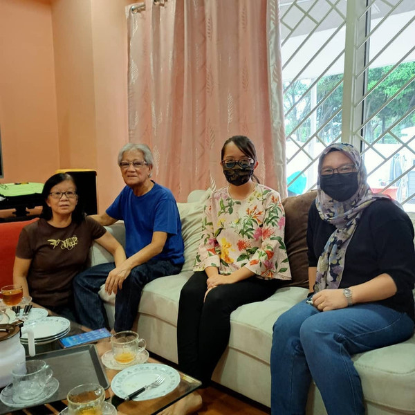 Ng (second from right) meeting Mohamad Noor at his home in January.