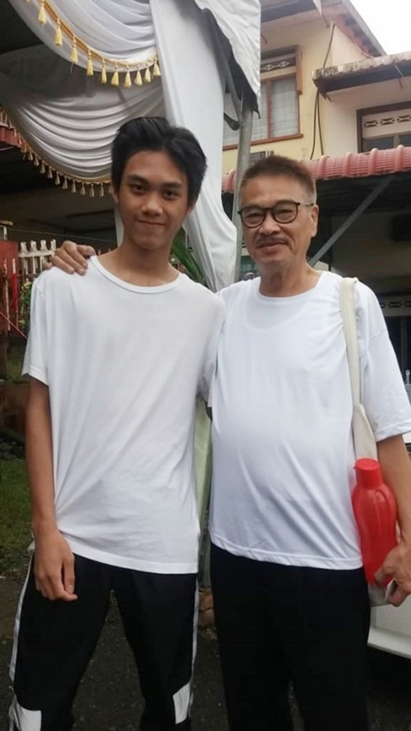 Ng Man Tat and his only son.