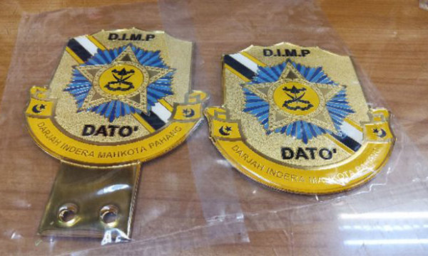 Badges, medals, and car emblems bearing Datuk titles have been found on sale online.