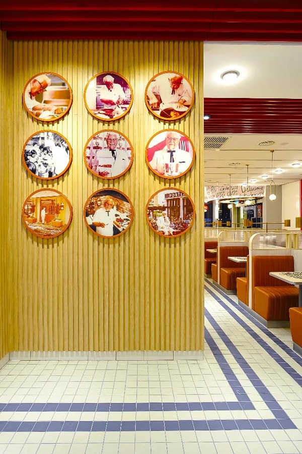 Wall of photos displaying Colonel Sanders, the founder of KFC.