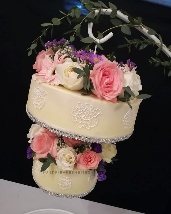 Hanging cake with fresh flowers.