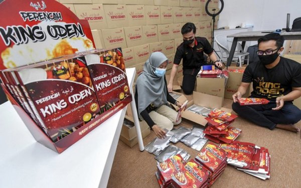 Wan Azehan Helmi Wan Abdul Halim and colleagues packing products at the King Oden shop in Kota Bharu.