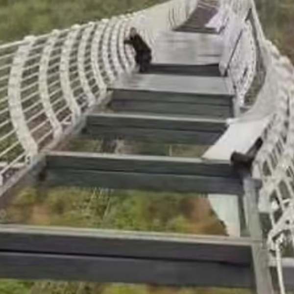 A photo of the tourist on the shattered glass-bottomed bridge.