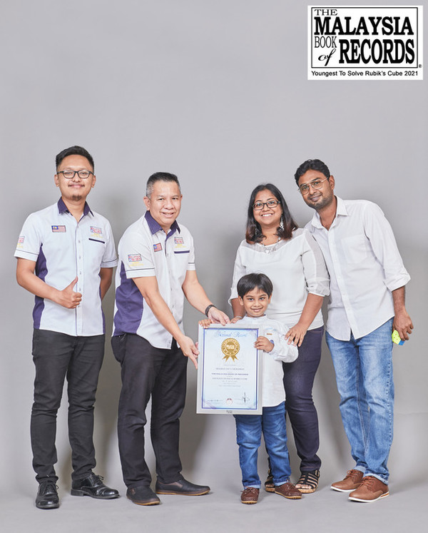 Thashan and his parents, Hashaa and Dubashan, receiving the record from MBR officials.