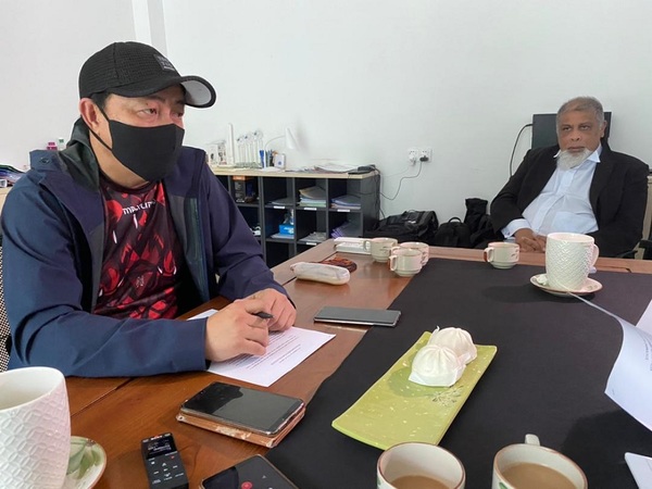 Philip Among (in the face mask) with lawyer Marcel Jude Joseph.