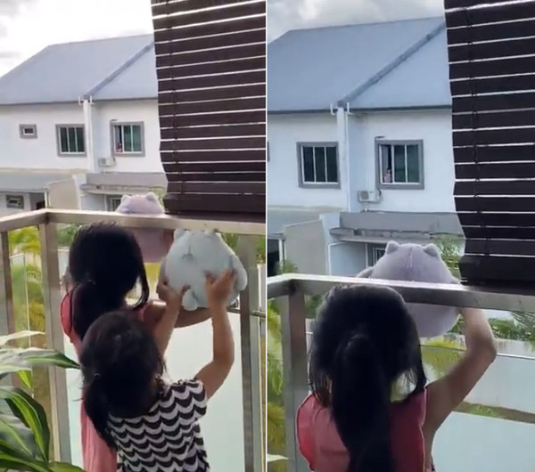 Hana, Lisa, and the neighbour showing each other their Totoro dolls.