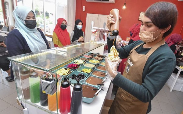 Hafizuddin serving customers at his shop.