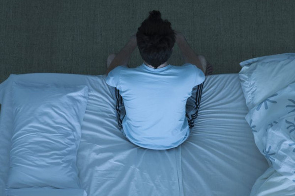 boy sitting on bed