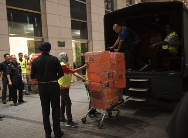 Boxes of handbags being seized from the condominium by police three years ago.