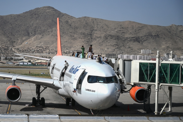 Afghans climbed to the top of an airplane as they waited at the Kabul airport.