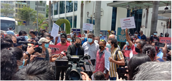 Global Human Rights Federation president S Shashi Kumar (middle, black suit) leading a group of people to lodge police reports against the preacher at Sentul district police headquarters yesterday, 3 October.