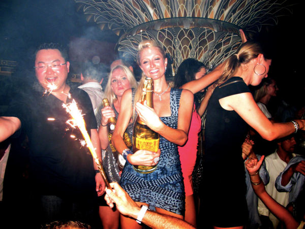 Jho Low with Paris Hilton at a nightclub in Saint-Tropez, France in 2010.