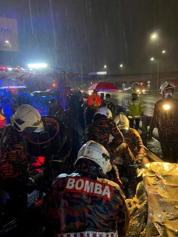 Rescuers remove the victims from their vehicles following the crash at the USJ Rest and Recuperation (R&R) area.